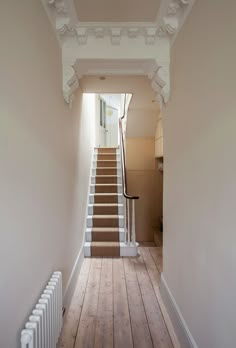 an empty hallway with stairs leading up to the second floor