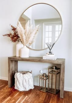 a mirror sitting on top of a wooden table