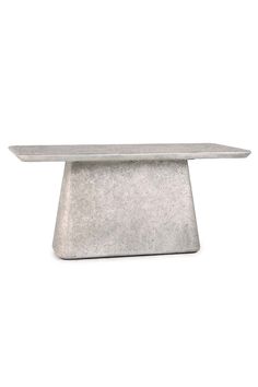 a concrete table sitting on top of a white floor