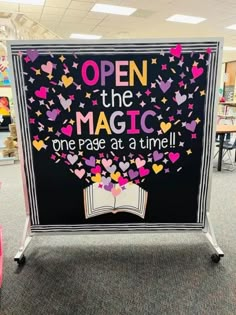 an open the magic one page at a time sign with hearts and stars on it