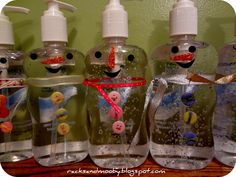 several bottles with different designs and colors on them, all decorated to look like snowmen