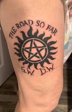 a person with a tattoo on their leg that says, the road so far ew down