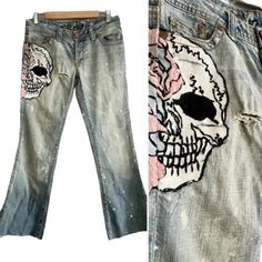 Vintage Grail Light-Wash Jeans With Skull. The Jean Features An Embroidered Skull On The Side, Light Wash With Bleach Spots, And A Distressed Look With Rips. The Fly Has Skull-Decorated Buttons And The Legs Have No Hems With Fraying. In Good Vintage Condition. With Some Loose Threads In The Embroidery. 98% Cotton 2% Lycra. Label Size 27. Measurements: Waist 30" Rise: 9" Inseam 28" Hips: 38" Embroidered Skull, The Fly, Light Wash Jeans, Label Sizes, Jeans And Boots, Bleach, Blue White, Women Jeans, Blue And White