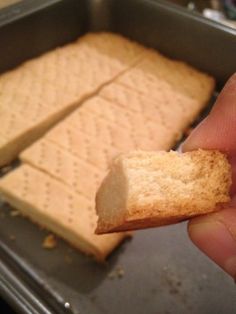 someone is holding a cracker in their hand and it looks like they are going to eat something