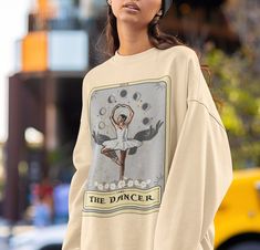 The Dancer Tarot Card Sweatshirt, Dancer Sweatshirt, Ballerina Sweater Ballet Dancer Gifts .: 50% cotton, 50% polyester .: Medium-heavy fabric (8.0 oz/yd² (271.25 g/m .: Loose fit .: Runs true to size Long Sleeve Graphic T-shirt For Dance, Graphic Print Long Sleeve Tops For Dance, Long Sleeve Graphic Print Tops For Dance, Long Sleeve Graphic Print T-shirt For Dance, Graphic Print Crew Neck Sweatshirt For Dance, Graphic Print Long Sleeve Sweatshirt For Dance, Crew Neck Graphic Print Sweatshirt For Dance, Cotton Graphic Print Sweatshirt For Dance, Long Sleeve Cotton T-shirt For Dance