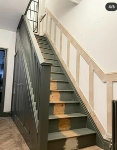 the stairs are painted green and white with wood treads on each handrail, which has been stripped off