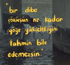 a man riding a bike in the water with a quote above it that reads, bir dise coursin ne kadar ogg yukestign tahuni