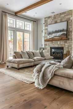 a living room filled with furniture and a fire place in front of a large window