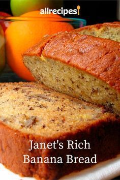 a loaf of banana bread sitting on top of a white plate next to an orange