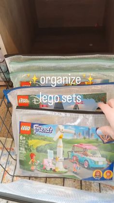 two bags with legos in them sitting on top of a shelf next to each other