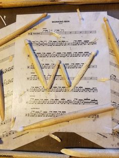 several pieces of music paper and pencils on top of sheet music