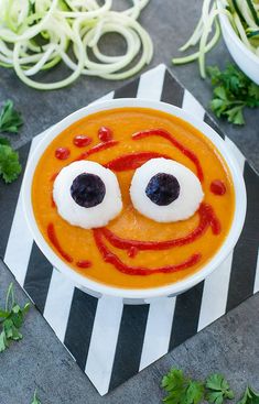 a white bowl filled with soup topped with googly eyes