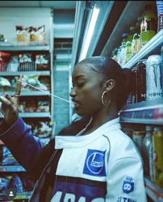 a woman in a grocery store looking at her phone