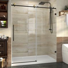 a bathroom with a walk in shower next to a white sink and brown tiled walls