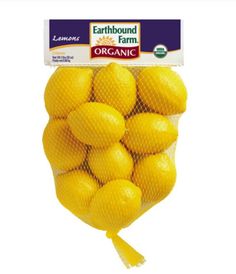 a bag of lemons sitting on top of a white table