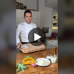 a man standing in front of a cutting board with food on it