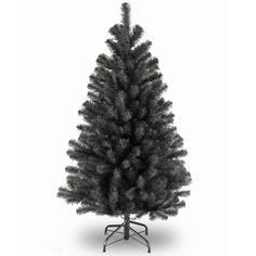 a black and white photo of a small christmas tree on a stand with no leaves