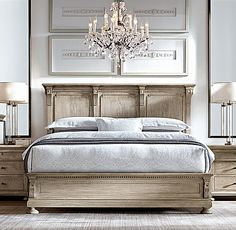 a bedroom with a bed, dressers and chandelier in the middle of it