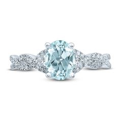 an aqua blue diamond ring with white diamonds