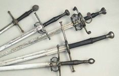 several different types of swords are displayed on a table