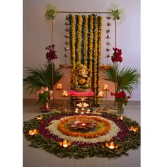 an image of a decorated stage with candles and flowers on the floor for diwaling