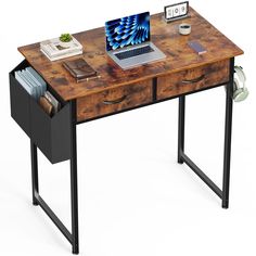 a laptop computer sitting on top of a wooden desk