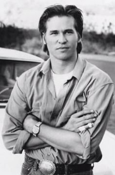 a black and white photo of a man with his arms crossed