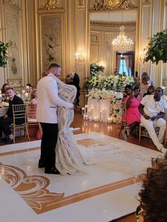 a bride and groom are getting married in the ballroom