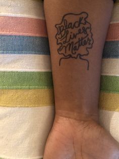 a person's arm with a tattoo that says back to the mother on it