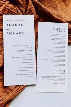 two wedding programs are laying on a bed