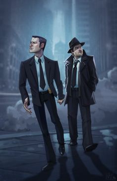 two men in suits and hats standing next to each other on a city street at night