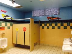 a bathroom with two urinals and three sinks on the wall next to each other