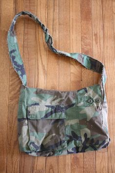 a camouflage bag sitting on top of a wooden floor