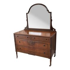 an antique dresser with mirror on top