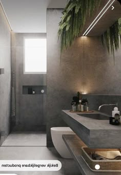 a bathroom with two sinks and a plant hanging over the bathtub in front of it