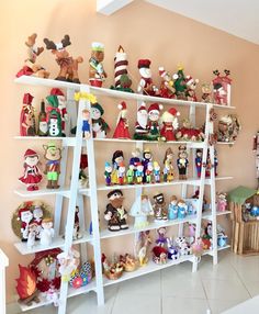 a shelf filled with lots of different types of christmas figurines on top of it