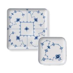 two blue and white plates sitting next to each other