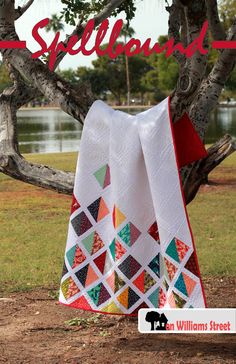 a quilted blanket sitting on top of a tree