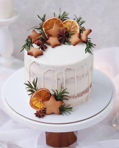 a white cake topped with orange slices and decorations