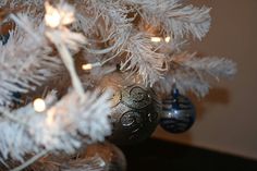 a white christmas tree with ornaments on it