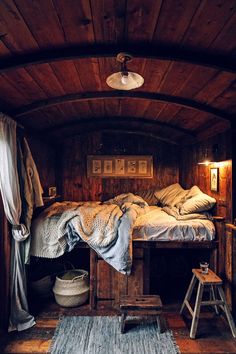 a bed in a room with wooden walls