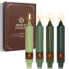 three candles are sitting in front of a box