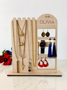 a wooden display with jewelry on it