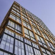 a very tall building with lots of windows on it's side and the sky in the background