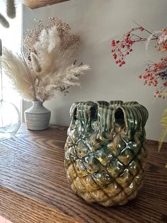 a vase sitting on top of a wooden table