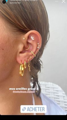 a woman wearing ear piercings with gold and diamonds