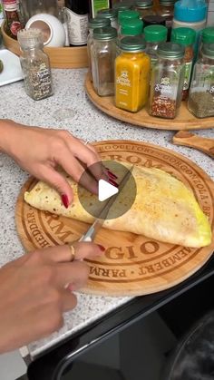 a person cutting up food on top of a counter