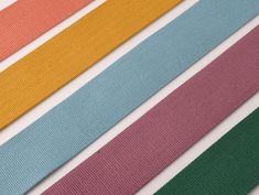 four different colors of ribbon sitting on top of each other