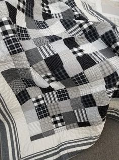 a black and white quilt is laying on the floor