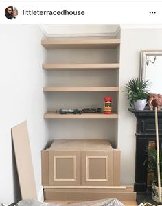 a room that has some shelves on the wall and other items in it, including boxes